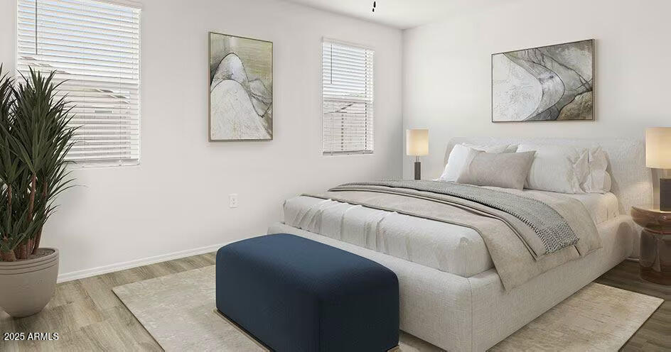 25200 North 151st Drive, Unit 5 Surprise, AZ 85387 - Photo 8 of 14 a bedroom with a bed and a potted plant