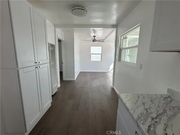 a view of hallway with wooden floor