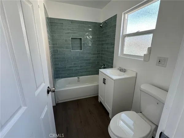 a bathroom with a sink toilet vanity and bathtub