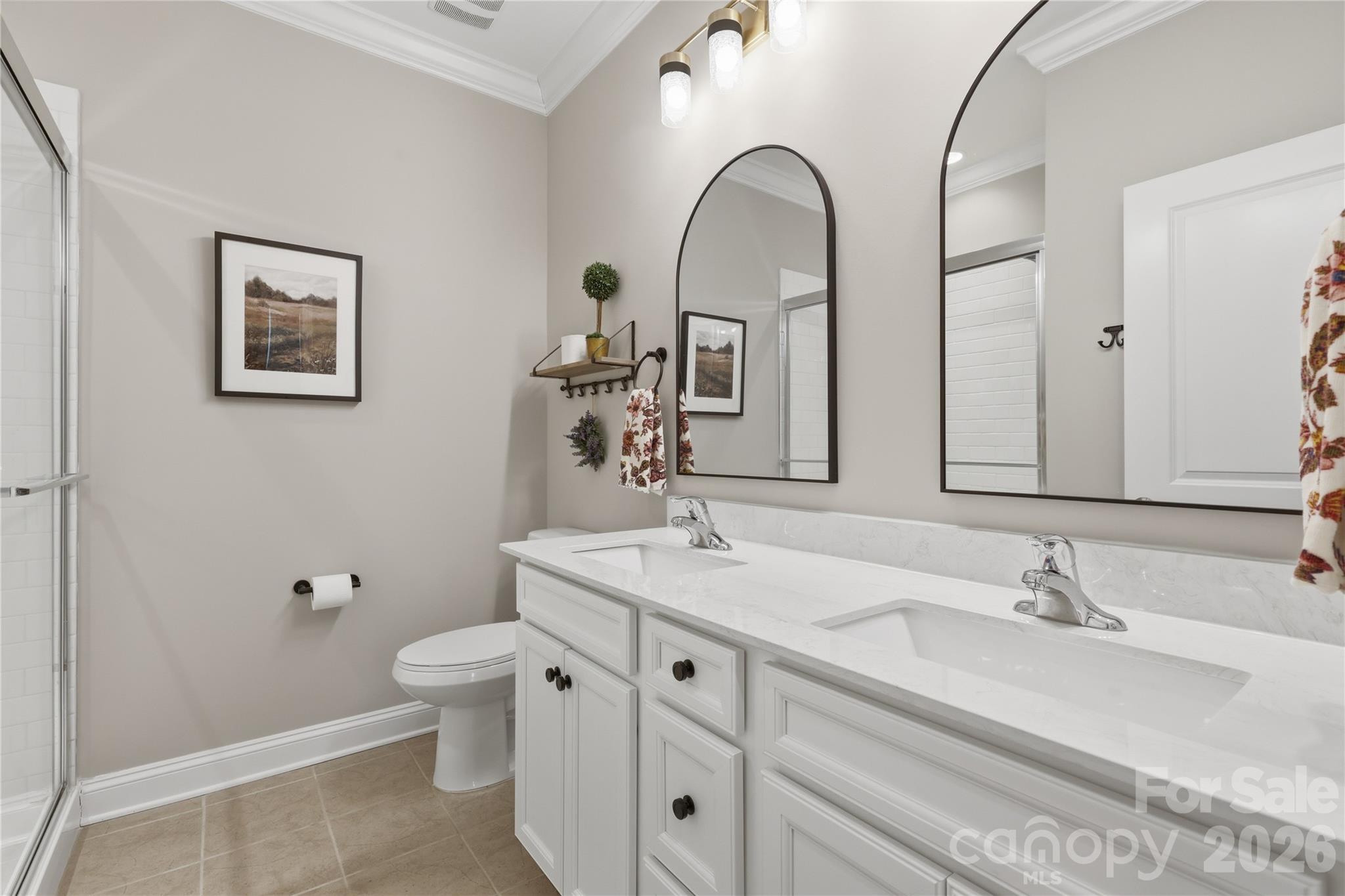 3023 Eagle Ridge Lane Indian Trail, NC 28079 - Photo 42 of 47 a bathroom with a double vanity sink toilet and a mirror