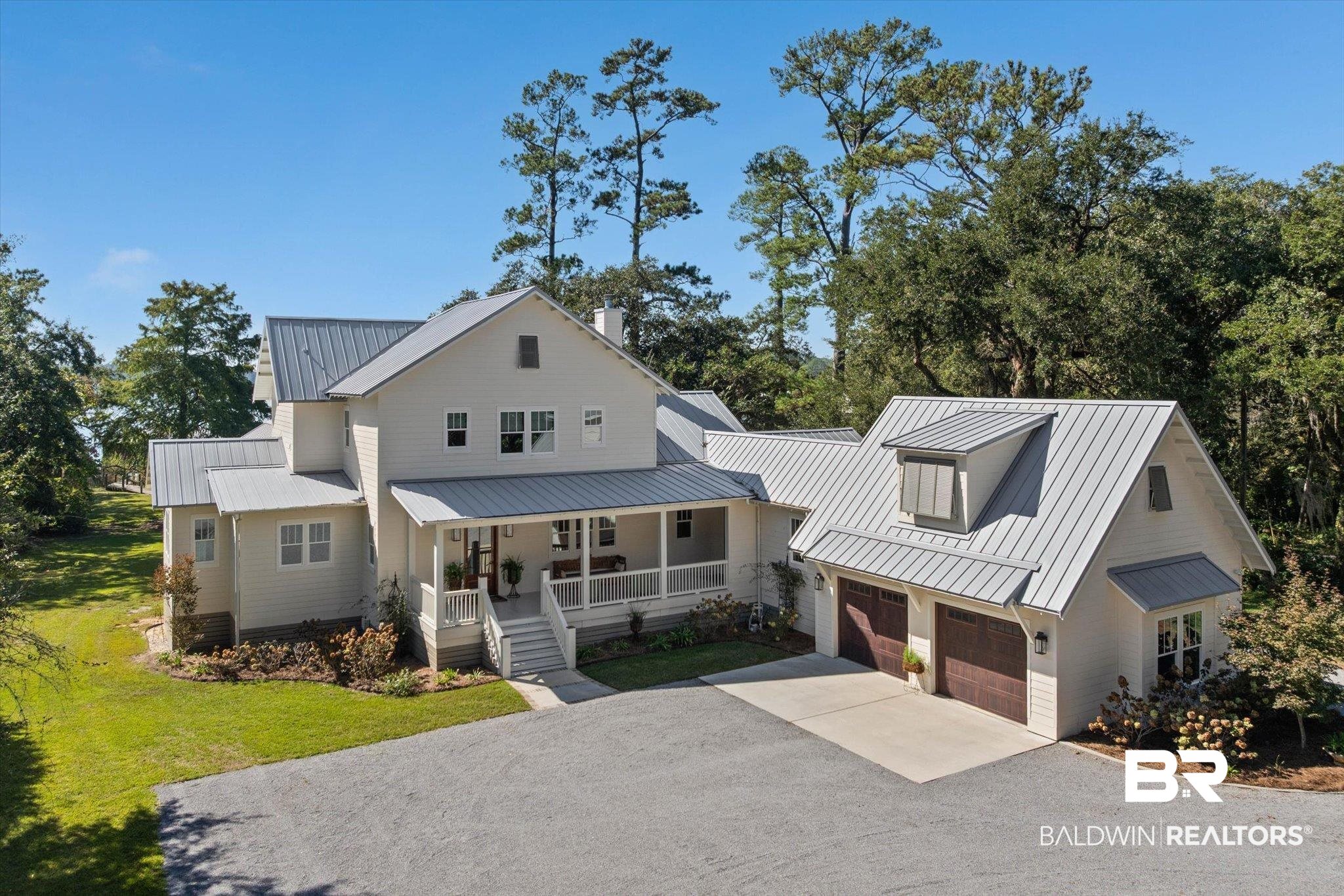 2415 Venetia Road Mobile, AL 36605 - Photo 1 of 50 Modern farmhouse with gravel driveway, covered porch, a garage, a metal roof, and a front yard
