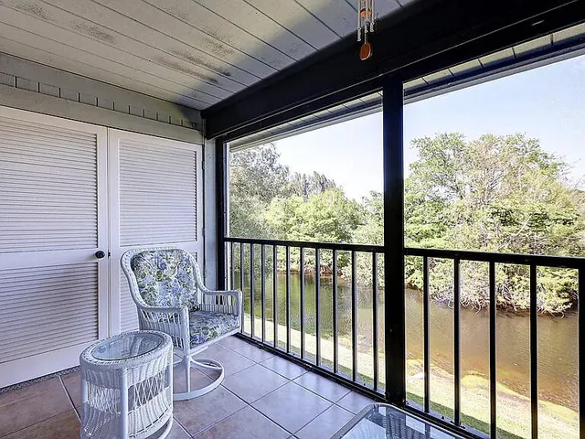 a backyard of a house with lots of green space and lake view