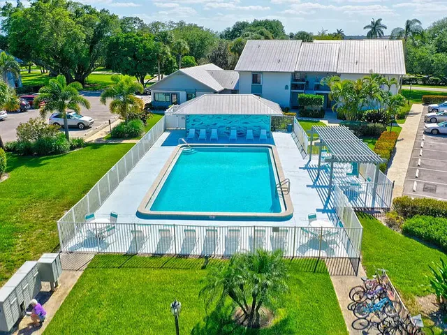 an aerial view of residential houses with outdoor space and swimming pool
