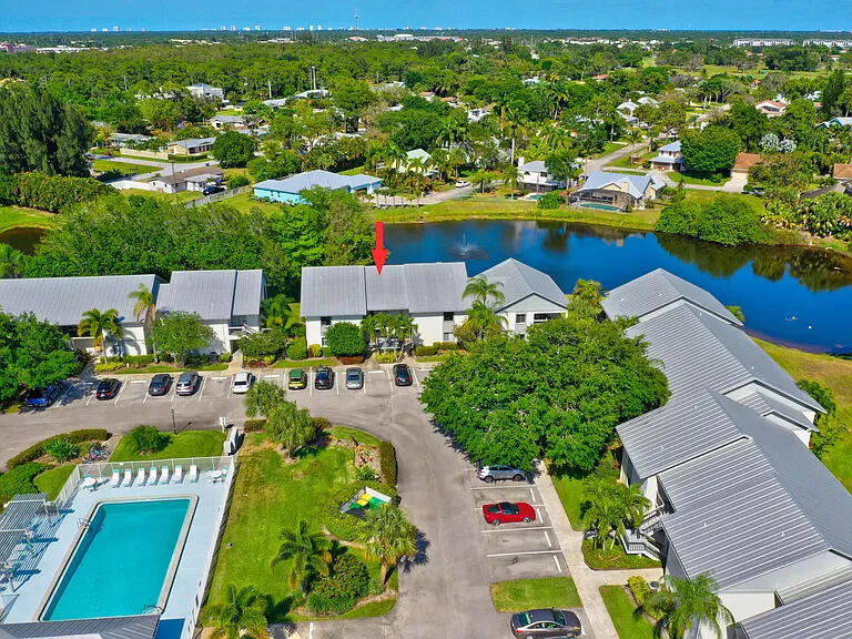 2243 Northwest 22nd Avenue, Unit 104 Stuart, FL 34994 - Photo 18 of 26 an aerial view of residential houses with outdoor space and swimming pool