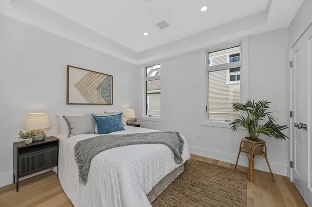 a living room with furniture a rug and wall paintings