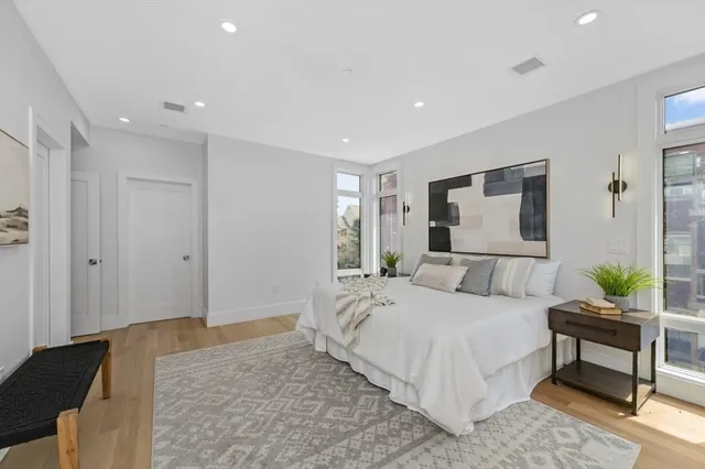 a bedroom with a large bed and a couch