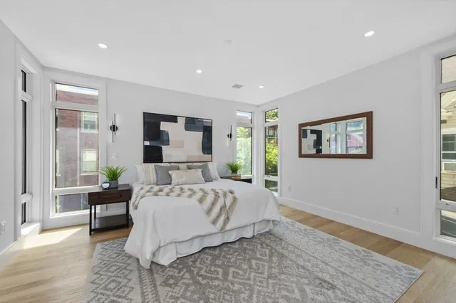 a bathroom with a double vanity sink toilet mirror and window