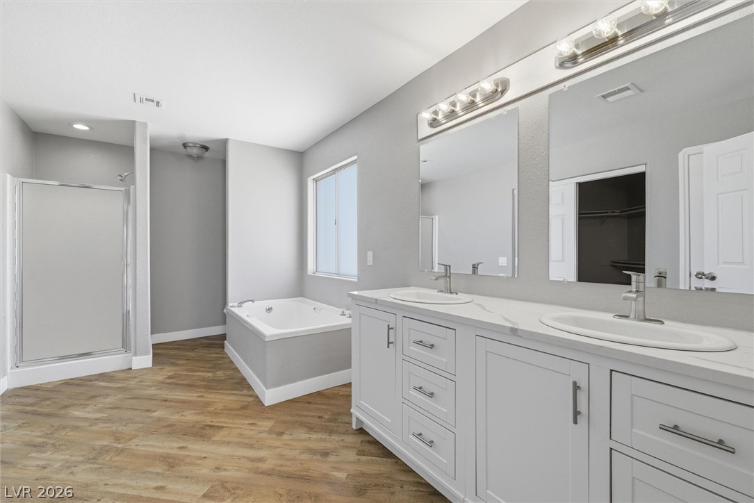 2780 West Simkins Road Pahrump, NV 89060 - Photo 25 of 40 A well-appointed primary bathroom showcases dual vanities, a separate shower, and a relaxing soaking tub.