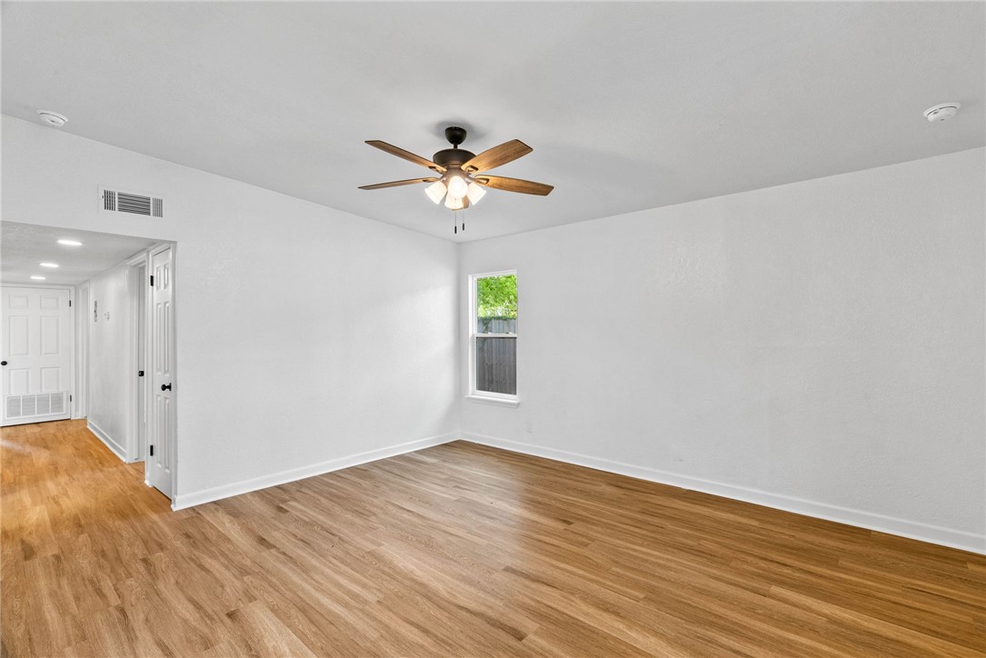 4018 Stirman Street Corpus Christi, TX 78411 - Photo 13 of 22 a view of an empty room with window and wooden floor