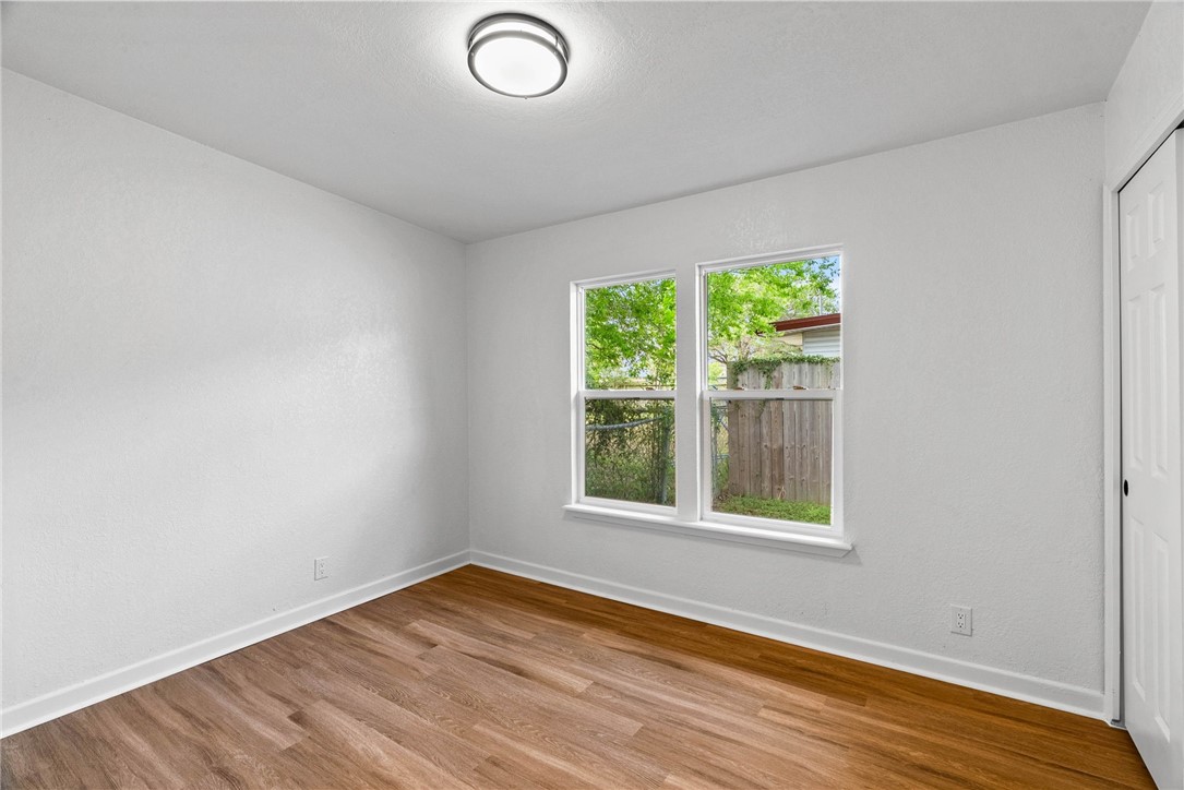 4018 Stirman Street Corpus Christi, TX 78411 - Photo 19 of 22 an empty room with wooden floor and windows