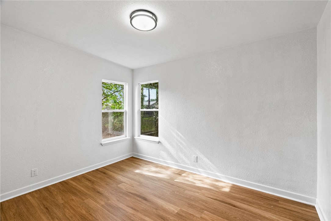 4018 Stirman Street Corpus Christi, TX 78411 - Photo 21 of 22 an empty room with wooden floor and windows