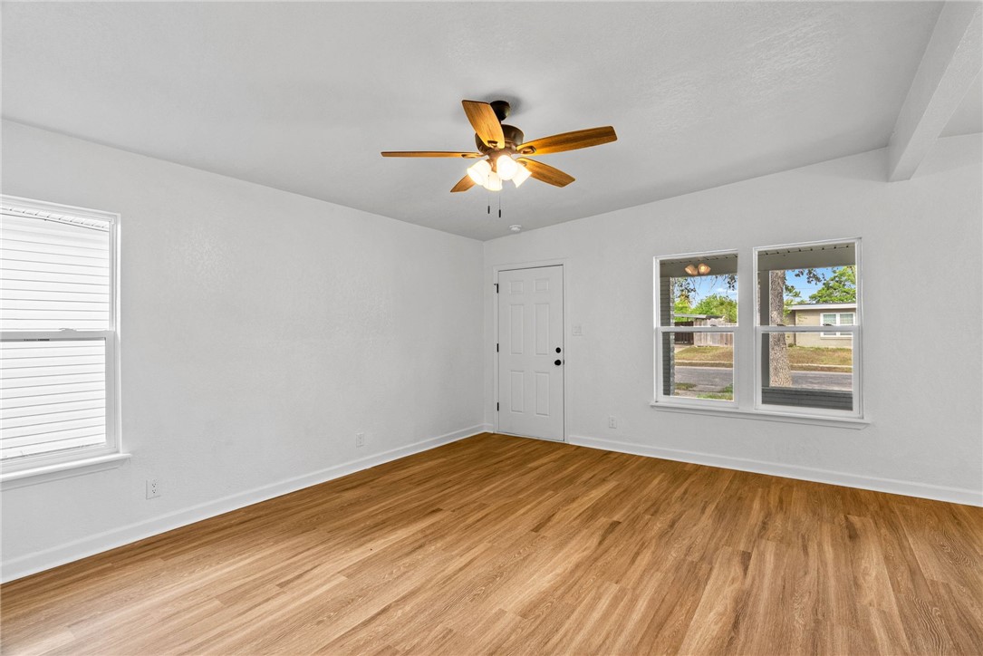 4018 Stirman Street Corpus Christi, TX 78411 - Photo 5 of 22 a view of empty room with wooden floor and fan