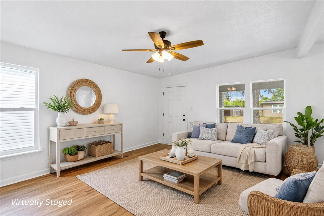 4018 Stirman Street Corpus Christi, TX 78411 - Photo 6 of 22 a living room with furniture a fireplace and a table