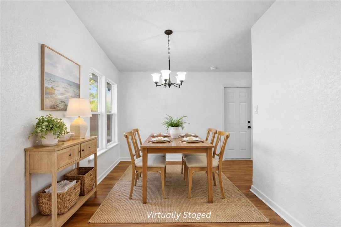 4018 Stirman Street Corpus Christi, TX 78411 - Photo 10 of 22 a dining room with furniture potted plants and wooden floor