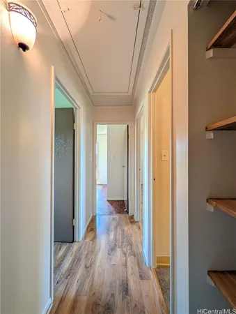 a view of a hallway with wooden floor and staircase