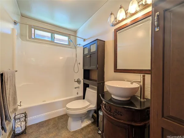 a bathroom with a toilet a sink and shower