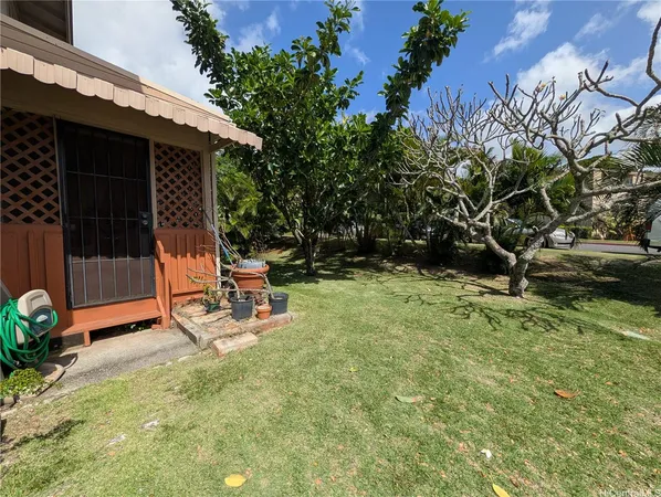 a view of a backyard with chair and table