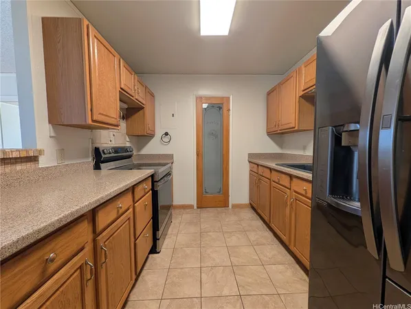 a kitchen with stainless steel appliances a sink stove and cabinets