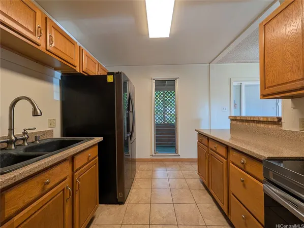 a kitchen with stainless steel appliances a sink cabinets and a refrigerator