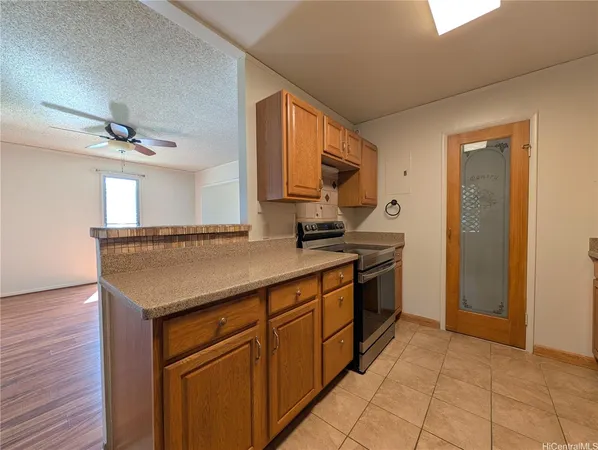 a kitchen with stainless steel appliances granite countertop a sink and a stove