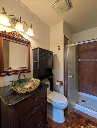 a bathroom with a sink a toilet and shower