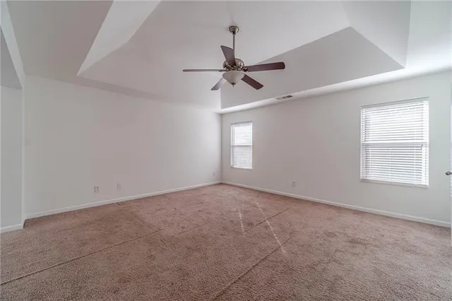 a view of empty room with ceiling fan