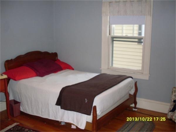 32 Thames Street Springfield, MA 01104 - Photo 6 of 10 a bedroom with a bed and a window