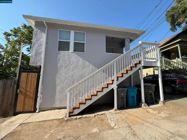 a view of a house with wooden fence