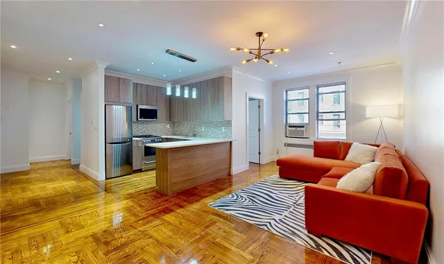 a kitchen with stainless steel appliances kitchen island granite countertop a refrigerator and a view of living room