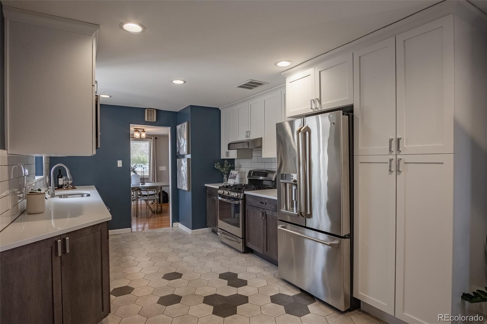 4000 Reed Street Wheat Ridge, CO 80033 - Photo 17 of 44 a kitchen with stainless steel appliances a refrigerator stove microwave and sink
