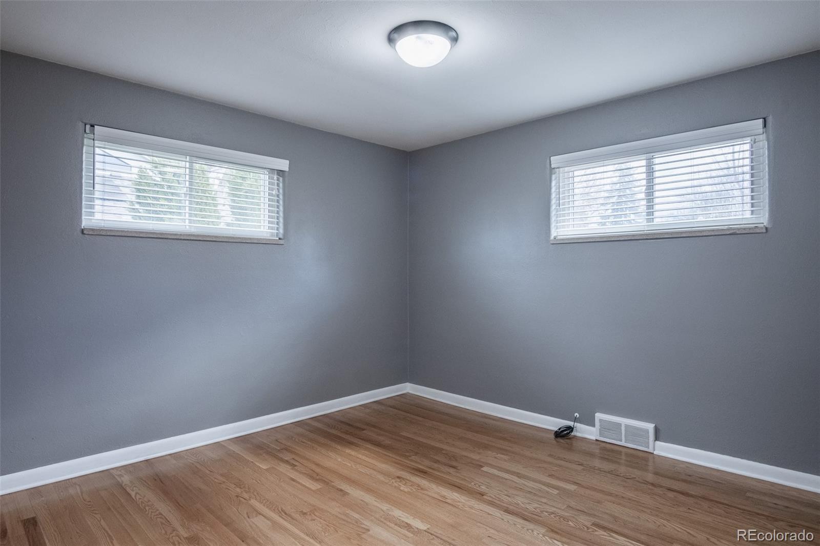 4000 Reed Street Wheat Ridge, CO 80033 - Photo 21 of 44 an empty room with wooden floor and windows