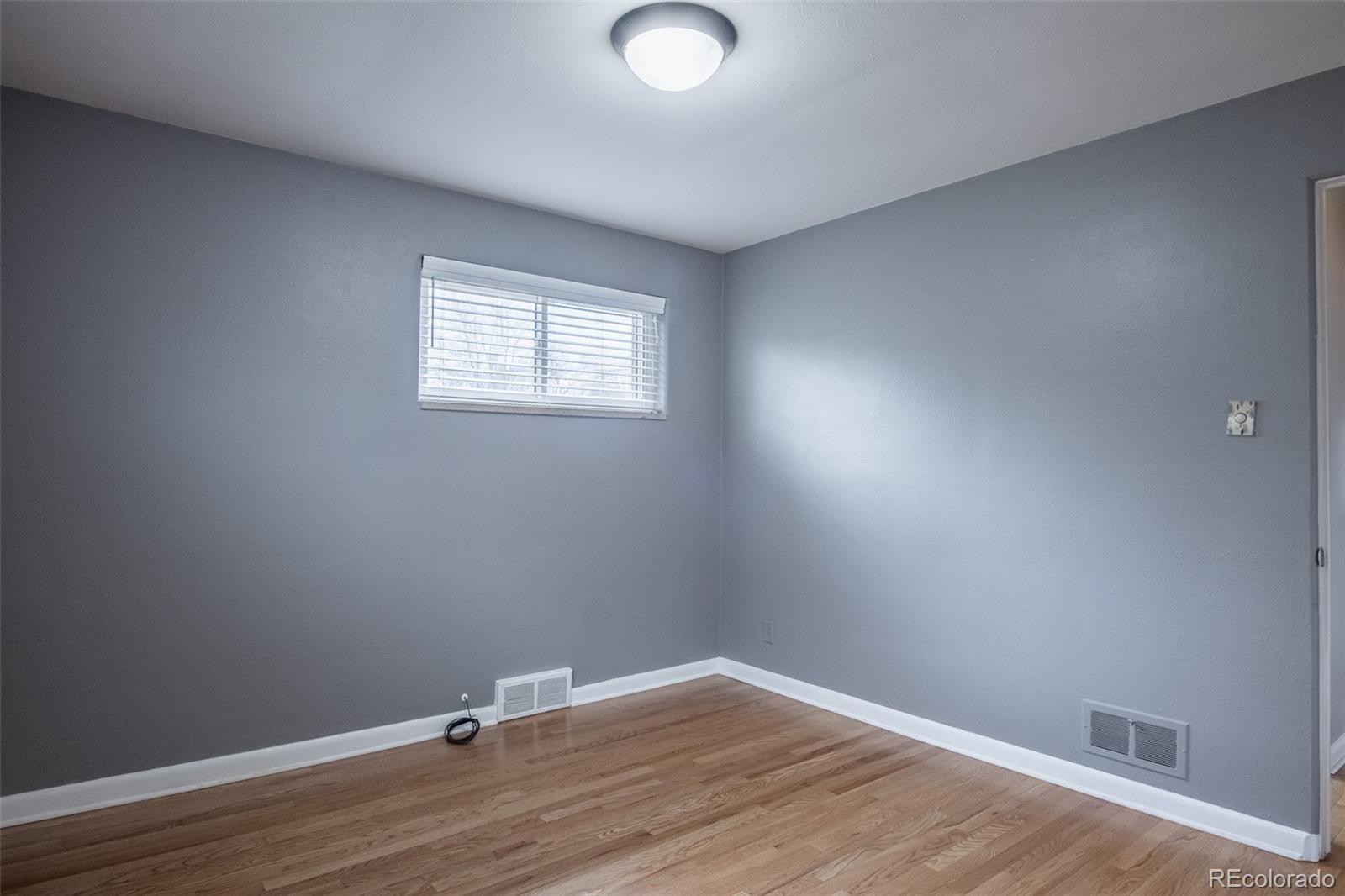 4000 Reed Street Wheat Ridge, CO 80033 - Photo 22 of 44 a view of an empty room with wooden floor and a window