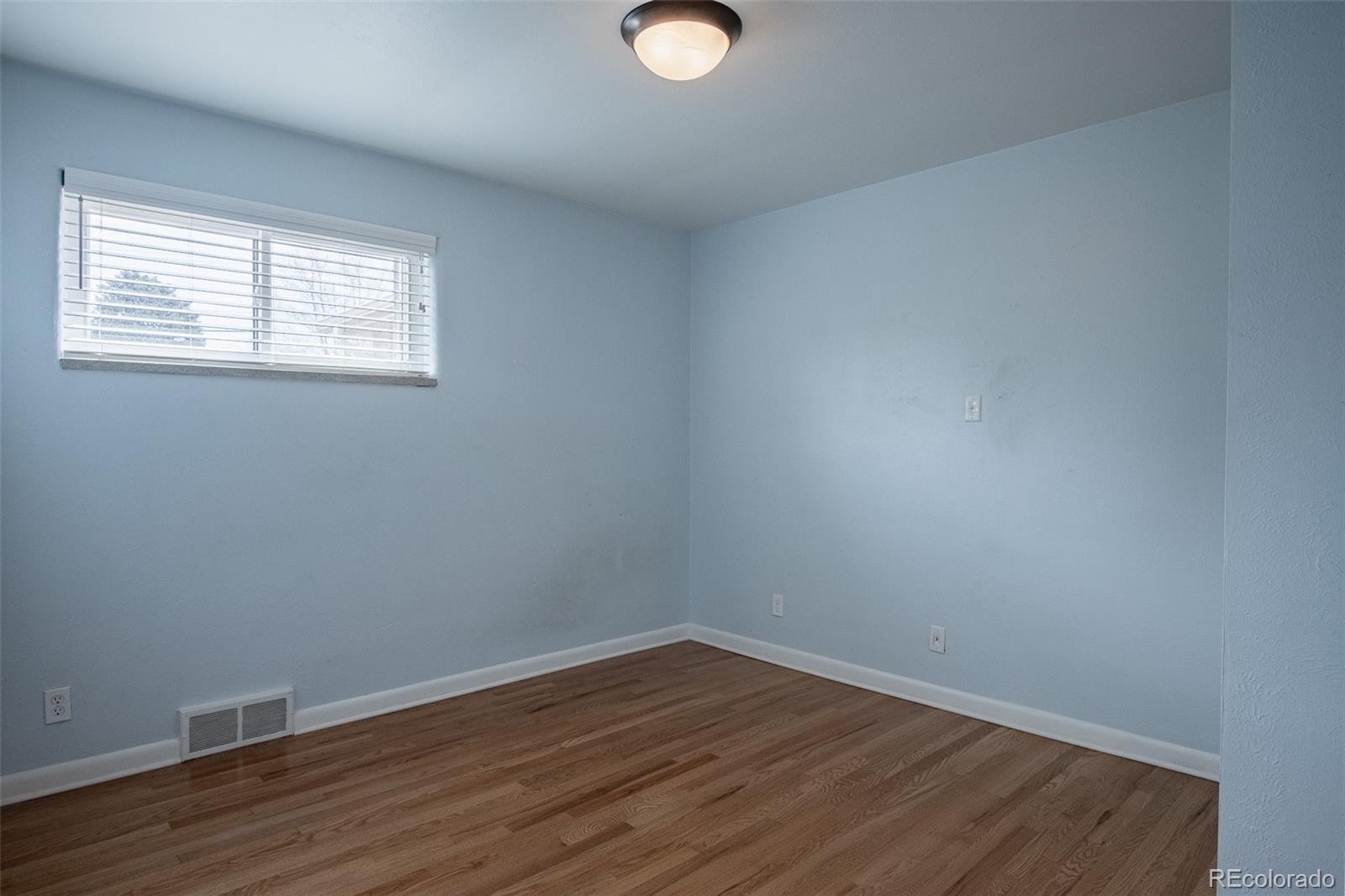 4000 Reed Street Wheat Ridge, CO 80033 - Photo 25 of 44 a view of an empty room with wooden floor and a window