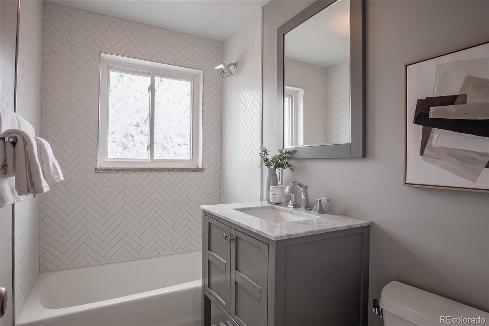 4000 Reed Street Wheat Ridge, CO 80033 - Photo 27 of 44 a bathroom with a sink toilet vanity and tub