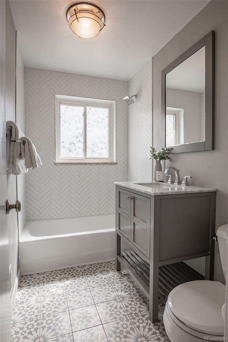 4000 Reed Street Wheat Ridge, CO 80033 - Photo 29 of 44 a bathroom with a sink a toilet and shower