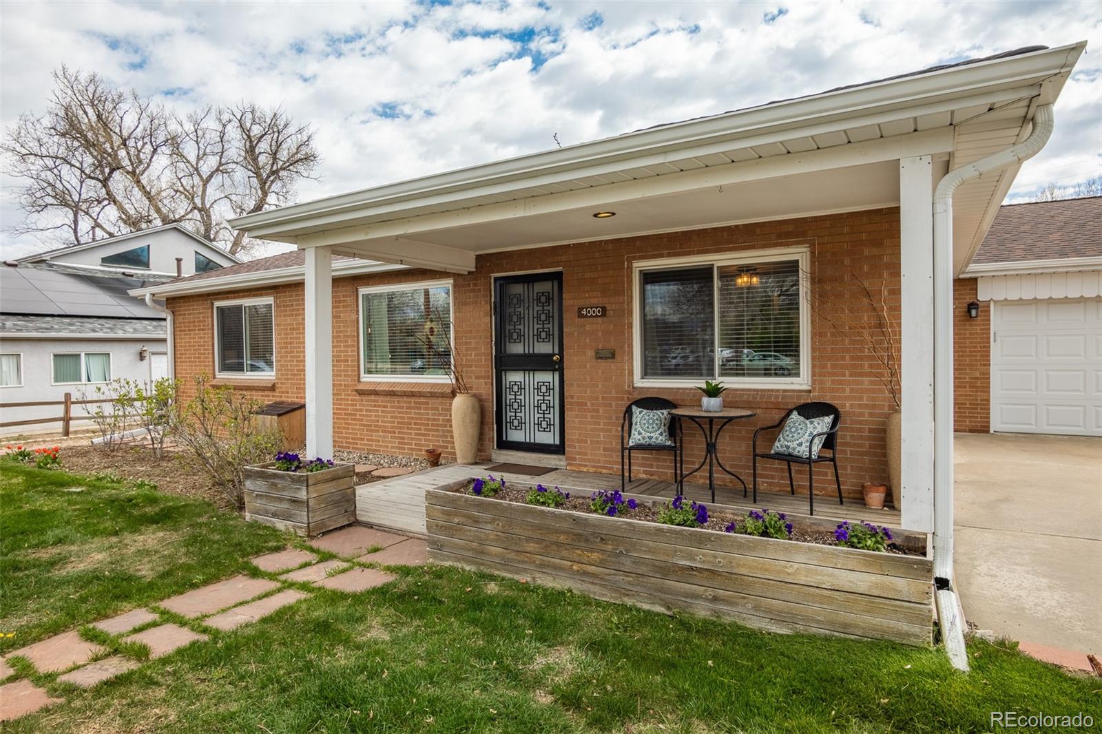 4000 Reed Street Wheat Ridge, CO 80033 - Photo 3 of 44 front view of a house with a patio