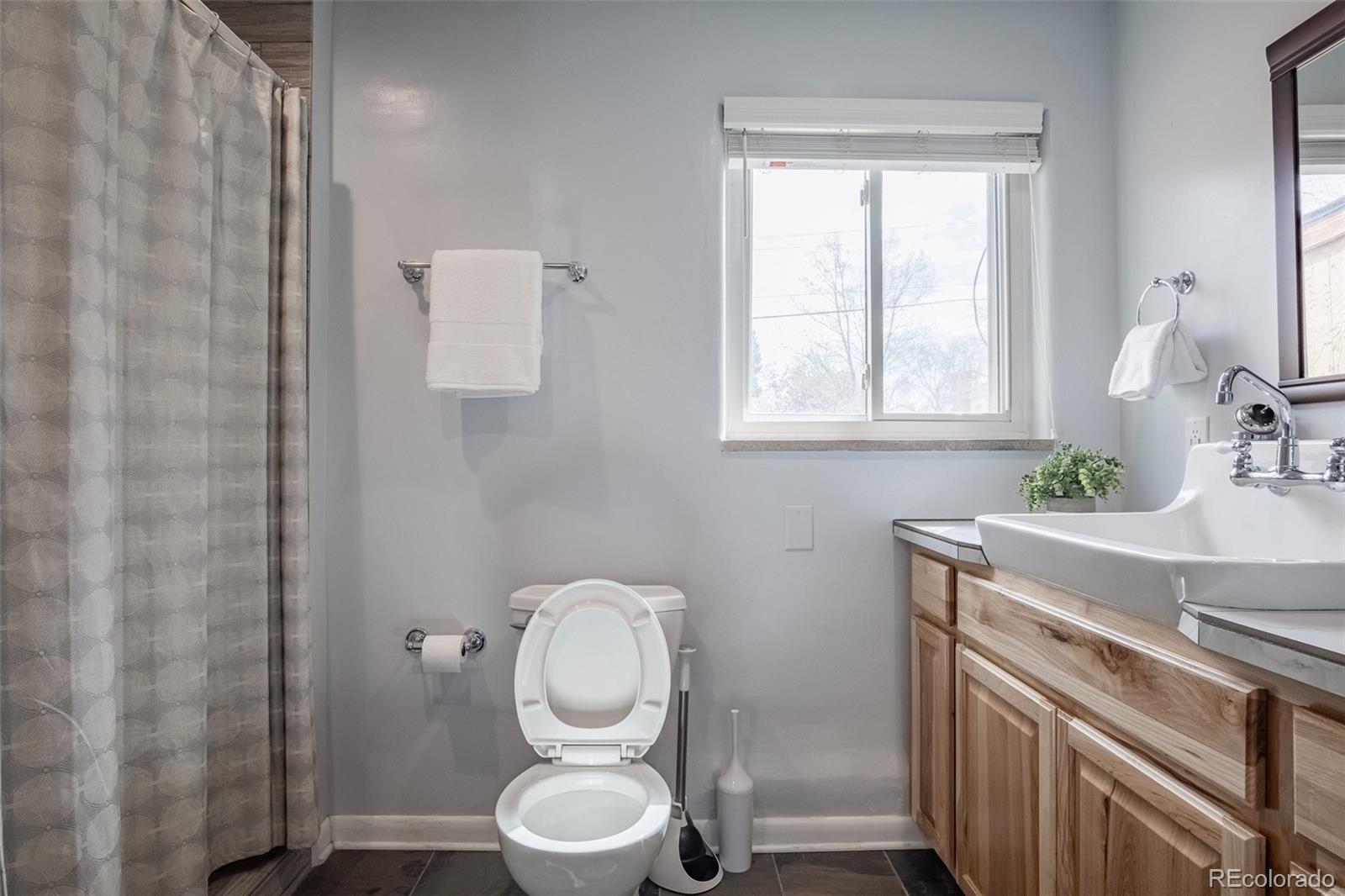 4000 Reed Street Wheat Ridge, CO 80033 - Photo 32 of 44 a bathroom with a sink a toilet and window