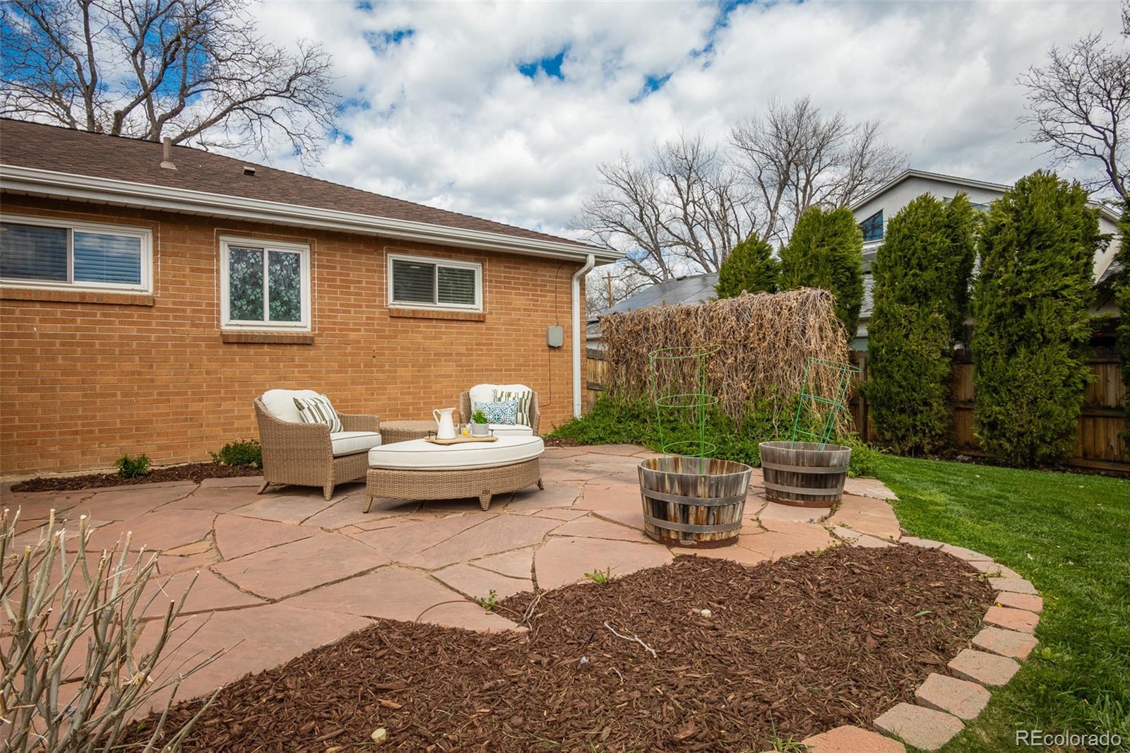 4000 Reed Street Wheat Ridge, CO 80033 - Photo 33 of 44 a view of a backyard with table and chairs and potted plants
