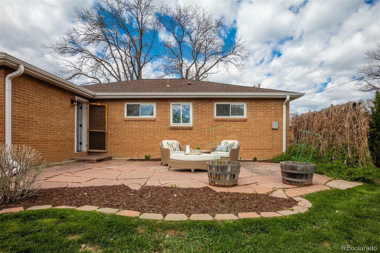 4000 Reed Street Wheat Ridge, CO 80033 - Photo 34 of 44 a backyard of a house with table and chairs