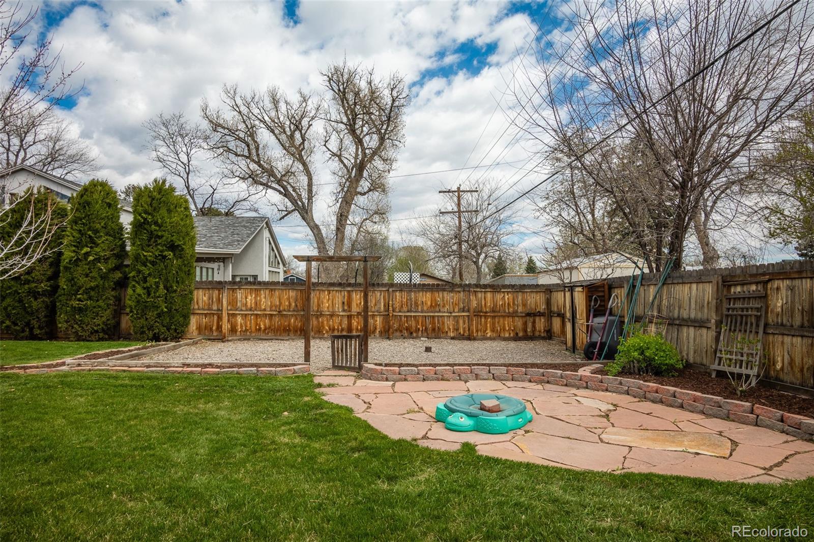 4000 Reed Street Wheat Ridge, CO 80033 - Photo 35 of 44 a view of a backyard with table and chairs and wooden fence