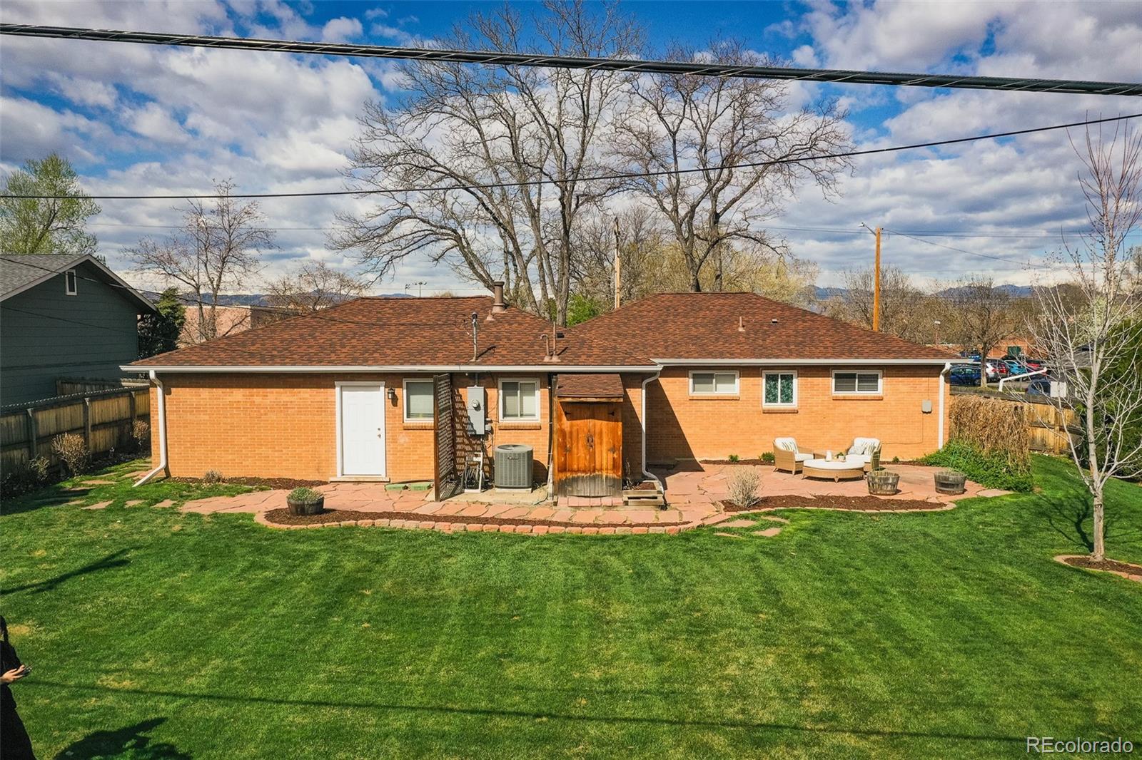 4000 Reed Street Wheat Ridge, CO 80033 - Photo 37 of 44 a view of a house with backyard and a tree