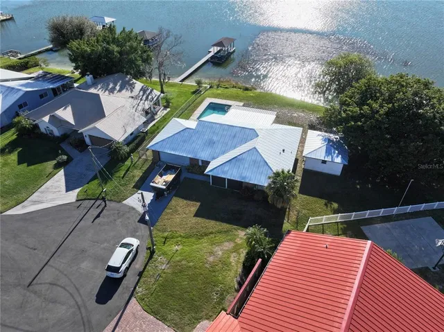 an aerial view of a house with swimming pool garden and patio