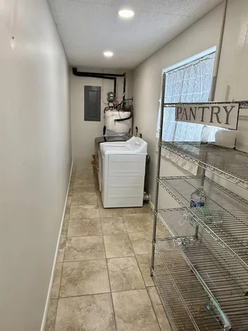 a room with a washing machine and cabinets