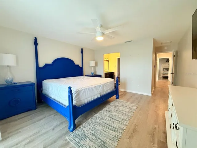 a bedroom with a bed lamp and a dresser