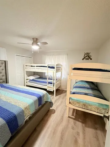 a bedroom with a bed and cabinet