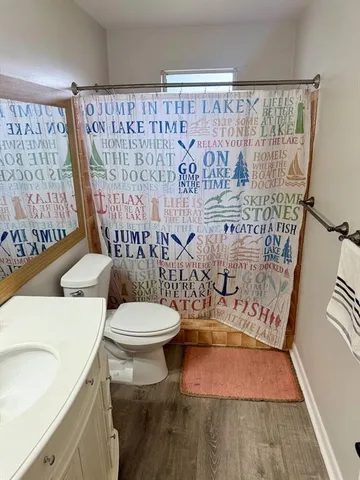 a bathroom with a toilet and a shower curtain