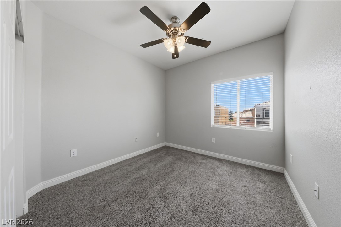 6312 Sandy Ridge Street, Unit 3102 North Las Vegas, NV 89081 - Photo 19 of 31 A well-lit bedroom with a window offering glimpses of the neighborhood.