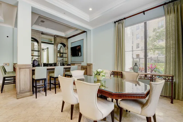 a dining room with furniture window and wooden floor