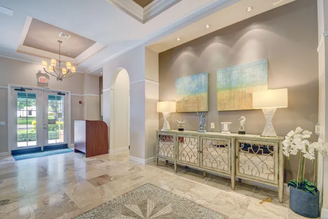 a living room with furniture a desk and a potted plant