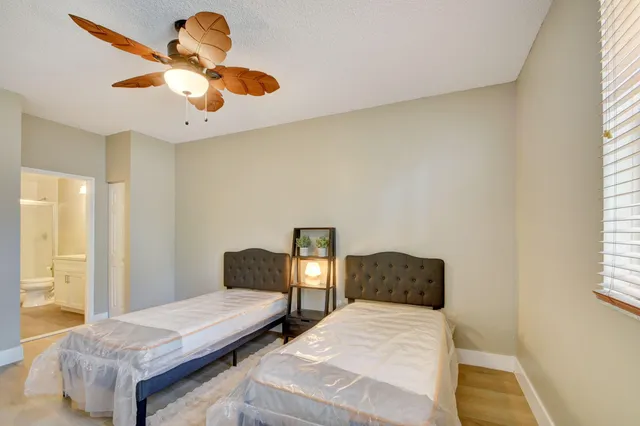 a bedroom with a bed and window